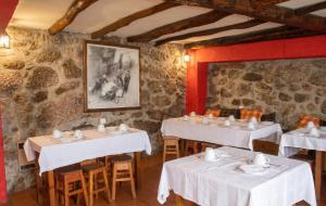 a restaurant with two tables with white tablecloths at Cosy Apartment Seia 25 m² Fireplace in Seia