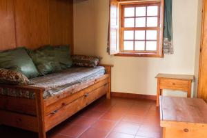 a room with a couch and a window and a table at Cosy Apartment Seia 25 m² Fireplace in Seia