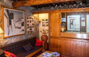 a living room with a couch and a mirror at Cosy Apartment Seia 25 m² Fireplace in Seia