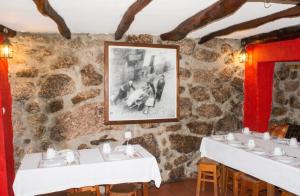 a room with three sinks in a stone wall at Cosy apartment in Seia, 25 sqm, welcoming fireplace in Seia +10 photos