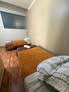 a room with two beds in a room at 4-Bedroom Apartment in Quillabamba