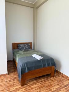 a bedroom with a bed with a towel on it at 4-Bedroom Apartment in Quillabamba