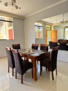 a dining room with a wooden table and chairs at 4-Bedroom Apartment in Quillabamba