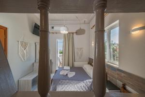 a bedroom with a bed and a window at Bikakis Family Apartments in Kissamos