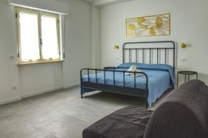 a bedroom with a bed and a couch at Casa Alice in Numana