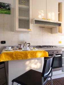 a kitchen with a counter with a yellow counter top at Charming Apartment in Velina, 90 m², Mountain View in Castelnuovo Cilento