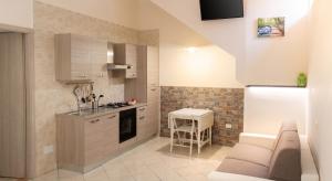a kitchen with a couch and a table in it at Charming studio with air conditioning in Gragnano - 35 sqm in Gragnano