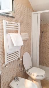 a bathroom with a white toilet and a sink at Charming studio with air conditioning in Gragnano - 35 sqm in Gragnano +17 photos