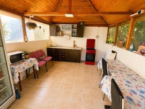 a kitchen with a table and chairs in a room at Casa Yva Black Sea in Venus