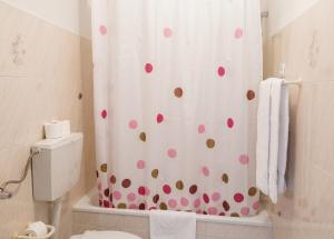 a bathroom with a shower curtain with polka dots at Charming Apartment in Alvoco da Serra with Mountain View in Alvoco da Serra