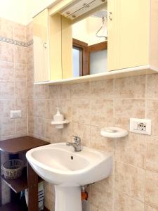 a bathroom with a sink and a mirror at S'Olivare Posada - Apartment in Posada