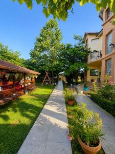 a walkway in a park with plants and buildings at Casa Yva Black Sea in Venus