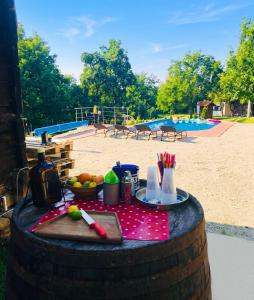 a picnic table in a barrel in front of a playground at Elegant villa with jacuzzi near Možđenec in Možđenec