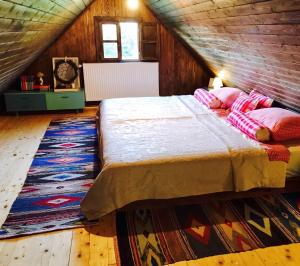 a bedroom with a bed with pillows and a rug at Elegant villa with jacuzzi near Možđenec in Možđenec +59 photos
