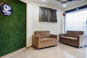 two chairs in a waiting room with a pittsburgh pirates sign at Collection O Dehu Alandi Road Formerly KP Pride in Dehu