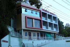 a building with a red stripe on top of it at Majestic Marvel in Maraiyūr +22 photos