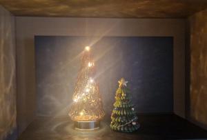 a christmas tree and a lighted christmas tree in a room at Villa Poppies Holidays - Noel et Nouvel An Villa avec spa privatif plage Ouistreham 14 pers Baby-Foot EVG Groups XXL Ouistreham Riva Bella D-Day Beaches in Ouistreham
