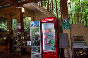 a coca cola machine in a room with at Aruna Mountain Lodge in Ban Huai Rin