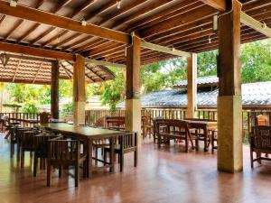 a group of tables and chairs under a pavilion at Aruna Mountain Lodge in Ban Huai Rin