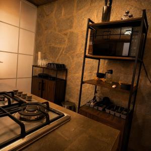 a kitchen with a stove and a counter top at Cabaña de lujo BlackMoon in Mazamitla +17 photos