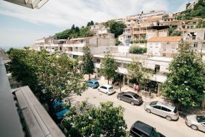 a city with cars parked in a parking lot at Accommodation Dolcino in Ulcinj