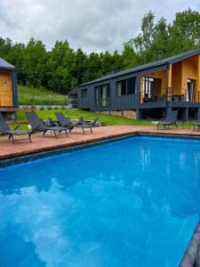 a house with a swimming pool in front of a house at Мої Гори in Pilipets