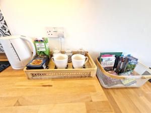 a tray with cups and other items on a table at 67 Broadside Holiday Chalet near Broads & Beaches in Stalham