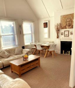 a living room with a couch and a table at Serenity Heights in Westgate-on-Sea