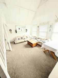 a living room with a couch and a table at Serenity Heights in Westgate-on-Sea