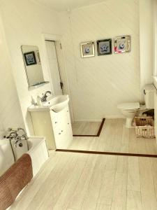 a white bathroom with a sink and a toilet at Serenity Heights in Westgate-on-Sea +7 photos