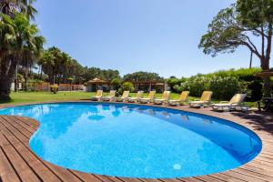 a large pool with chairs and a playground at Casa do Marco in Sintra