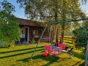 two chairs on a swing in a yard at Schneiderhof Ferienwohnung mit Alpenblick in Fischbachau +11 photos