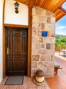 a door to a house with a stone wall at Apartamento Cholo in Brañosera