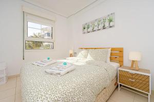a bedroom with a bed with towels on it at Appartement Capitolio Albir 1G in Albir +20 photos