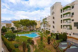 an apartment complex with a swimming pool in a park at Appartement Capitolio Albir 1G in Albir