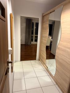 a hallway with a door and a mirror at Apartament Miejski Azyl in Rybnik