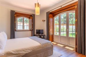 a bedroom with a bed and a sliding glass door at Casa do Marco in Sintra +88 photos