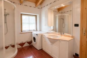 a bathroom with a sink and a washing machine at Appartamenti Pollam by AMA Val di Fassa in Pozza di Fassa +33 photos
