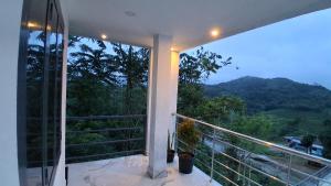 a balcony with a view of a mountain at Venus Valley Vagamon in Vagamon