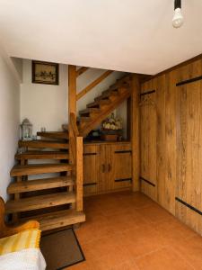 a staircase in a room with wooden walls at Siedlisko Mieruniszki in Mieruniszki