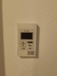 a white microwave on a wall in a room at Pensión Pastoriza in Vimianzo