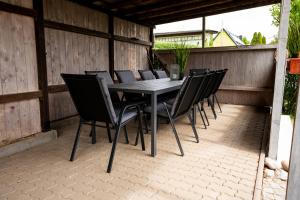 a black table and chairs on a patio at Elbsandsteinlodge in Sebnitz