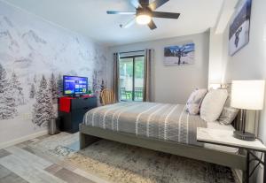 a bedroom with a bed and a tv on a wall at Killington resort: Walk to Mountain, Biking & Pool in Killington