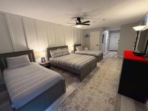 a bedroom with two beds and a ceiling fan at Killington resort: Walk to Mountain, Biking & Pool in Killington