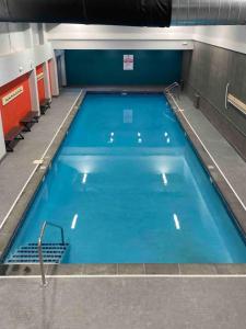 a large swimming pool with blue water at Killington resort: Walk to Mountain, Biking & Pool in Killington
