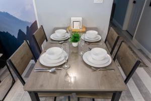 a wooden table with plates and silverware on it at Killington resort: Walk to Mountain, Biking & Pool in Killington +57 photos