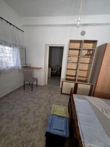 a room with a bed and a desk and a table at Chora Residence in Khóra