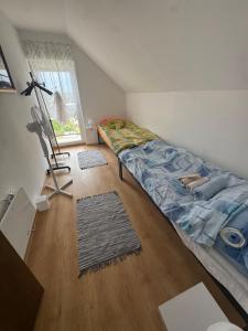 a bedroom with a bed in the corner of a room at Weekendica Aljmaš in Aljmaš