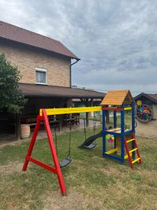 a playground with a seesaw and a swing set at Weekendica Aljmaš in Aljmaš