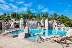 a swimming pool with a waterfall in a resort at Sheraton Grande Tokyo Bay Hotel in Urayasu